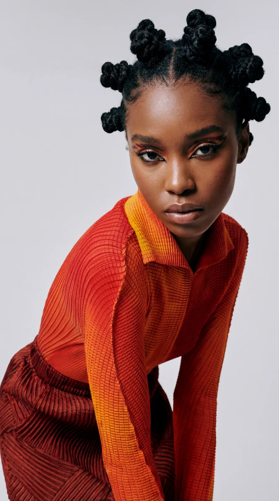 AI model in an orange editorial look